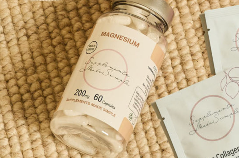 Bottle of Magnesium Citrate Supplements by Supplements Made Simple containing 60 capsules placed on a textured woven surface beside collagen sachets.