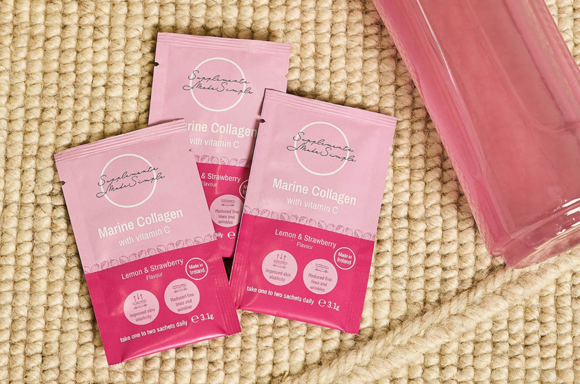 Lemon & Strawberry Marine Collagen sachets with Vitamin C from Supplements Made Simple beside a shaker bottle.