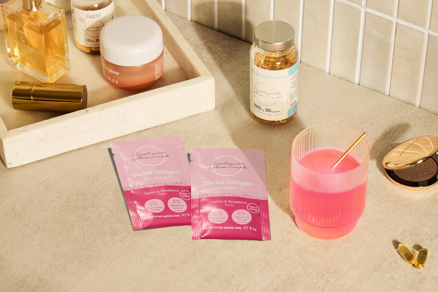 Lemon and Strawberry Marine Collagen sachet held against a soft pink background